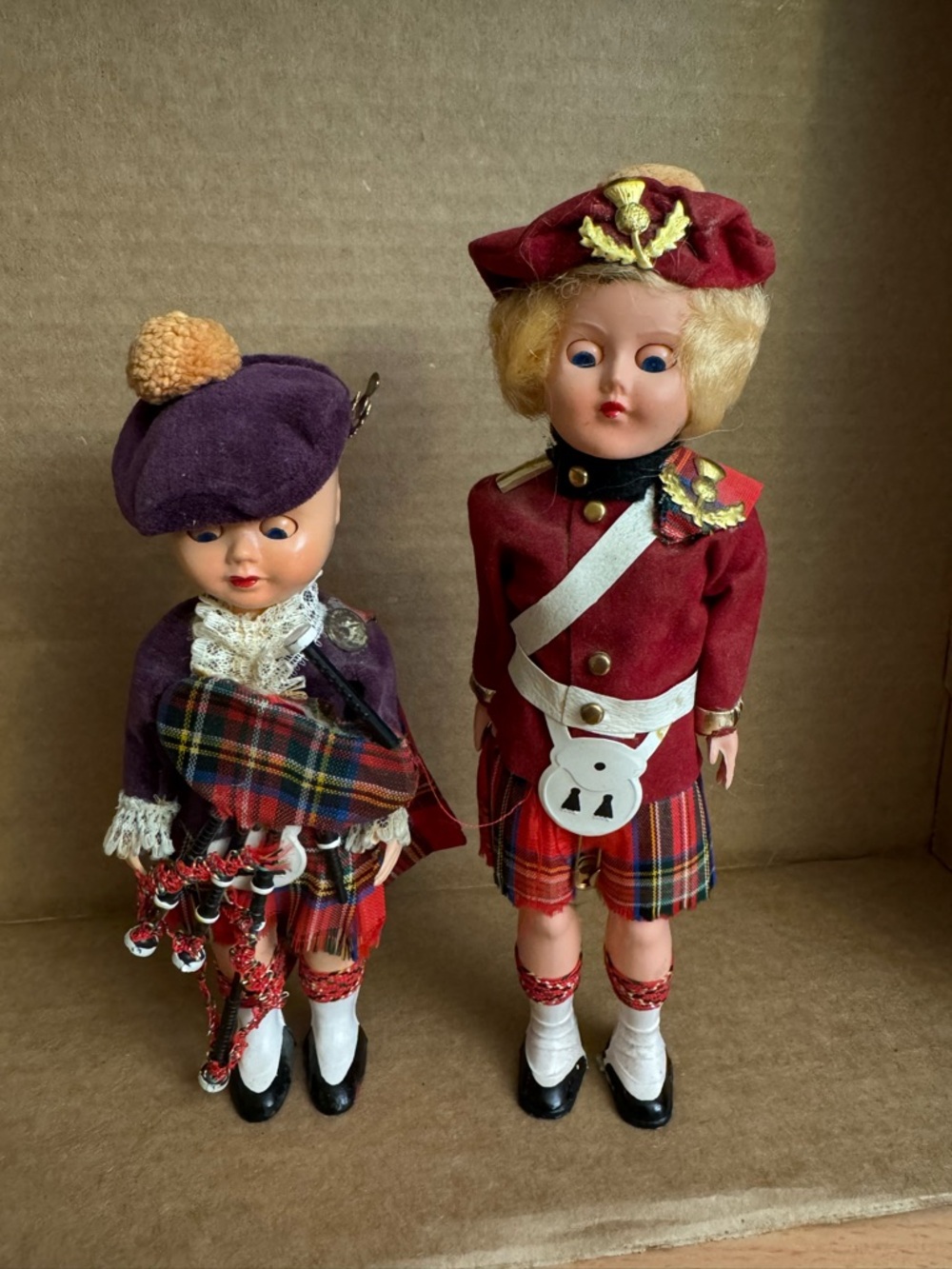 2 Scottish dolls. The one in purple is 6 1/4" tall, the other is 7 1/2".